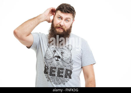Confused thoughtful bearded man scratching his head over white background Stock Photo