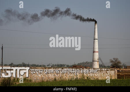 A brick clan emitting black smoke from its chimney in suburbs of New Delhi, India Stock Photo