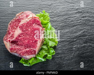 Steak Ribeye on the black graphite background. Stock Photo