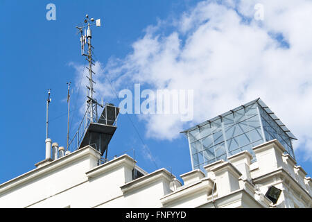 Meteorological devices on roof over blue sky Stock Photo