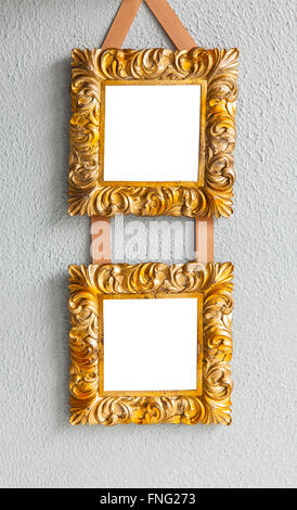 Image of ornate gilded mockup frames hanging on a wall. Stock Photo