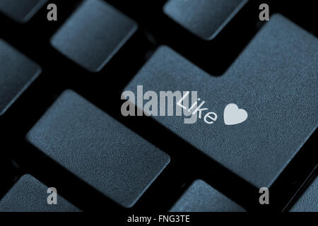 Horizontal close up of black keys on a keyboard with the word like and a heart icon on one of them Stock Photo