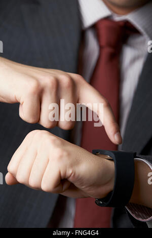 Close Up Of Businessman Using Smart Watch Stock Photo
