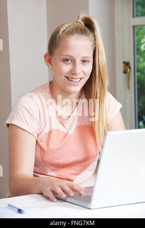 Portrait Of Girl Using Laptop At Home Stock Photo