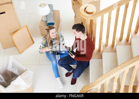 Couple Celebrating Moving Into New Home With Champagne Stock Photo