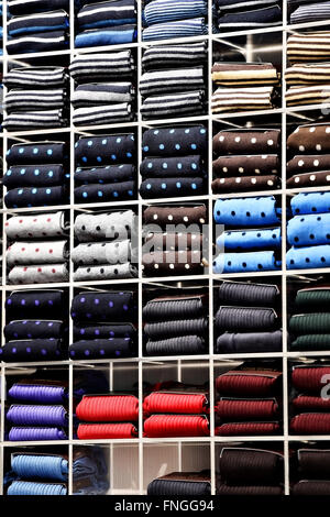 Different silk neckties packed on shelves in a store Stock Photo