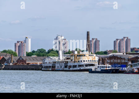 Royal Iris - old rusty abandoned ferry moored and Barrier Gardens Pier on the River Thames, London Stock Photo