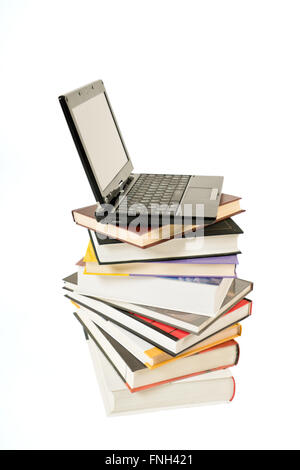 Stack of book and laptop isolated on white background Stock Photo