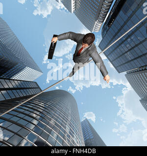 businessman balancing on a rope Stock Photo