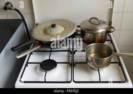 pans and pots on a gas cooker Stock Photo