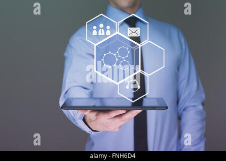 businessman hand touch  gear to success as concept. Business man using tablet PC. Stock Photo