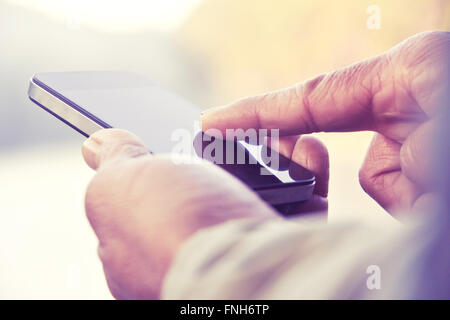 man texting on his smartphone Stock Photo