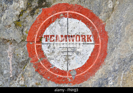 Single word Teamwork in the center of a red circle on textured background Stock Photo