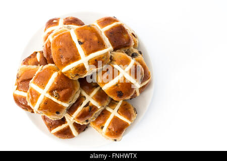 A plate full of freshly baked Easter, hot cross buns on an isolated white background. A view from above looking down. Stock Photo