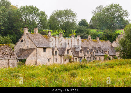 The row of 14th Century cottages are Arlington Row in Bibury , Gloucestershire , England , Britain , Uk