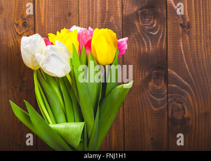 Bouquet Of Tulips In Front Of Spring Scene On The Wooden Background. A bouquet of flowers for March 8, or Valentine's day Stock Photo