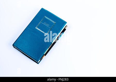 Blue green leather diary notebook with pencil isolated on white background Stock Photo