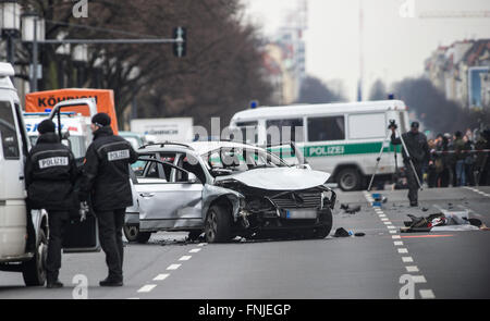 Berlin, Germany. 15th Mar, 2016. Police officers standing by a damaged car, on Bismarckstrasse in Berlin, Germany, 15 March 2016. The driver died when an explosion occurred in the vehicle while it was moving. PHOTO: PAUL ZINKEN/DPA/Alamy Live News Stock Photo