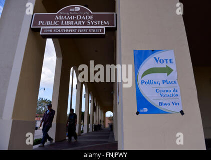 Miami, USA. 15th Mar, 2016. Pedestrians walk by a polling station in Miami, Florida, the United States, March 15, 2016. New York billionaire developer Donald Trump on Tuesday took a stride towards locking up the 2016 Republican presidential nomination after a crucial victory in the winner-take-all Florida primary, according to local media projection. © Yin Bogu/Xinhua/Alamy Live News Stock Photo