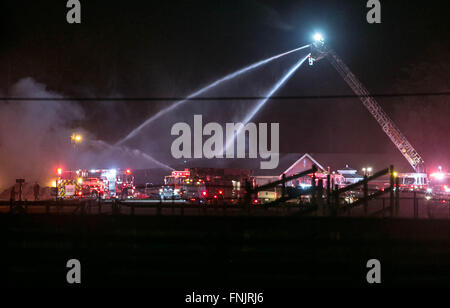 Lake Worth, Florida, USA. 16th Mar, 2016. A two-alarm fire destroyed a 200 foot-long barn at the South Florida Trotting Center in Western Lake Worth. The fire started around midnight and caused the roof to collapse. The fate of thirty horses in the barn are unknown at this time according to Palm Beach County Fire Rescue Capt. Albert Borroto. Credit:  Allen Eyestone/The Palm Beach Post/ZUMA Wire/Alamy Live News Stock Photo