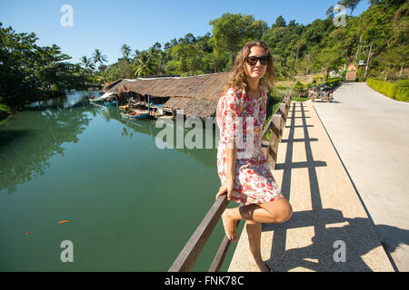 Young woman on the street in an Asian village. Journey. Stock Photo