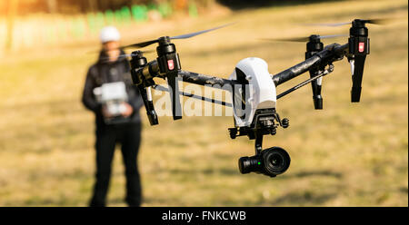 Man handling drone in nature, focused on drone Stock Photo