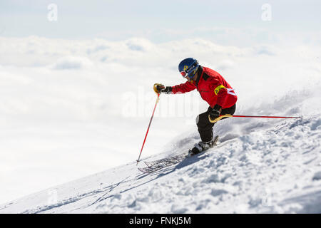 Sofia, Bulgaria - March 12, 2016: Freestyle skier is skiing at the top of a snowy peak of Vitosha mountain covered in clouds. He Stock Photo