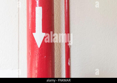 Red pipe have arrow on it and pointing direction Stock Photo