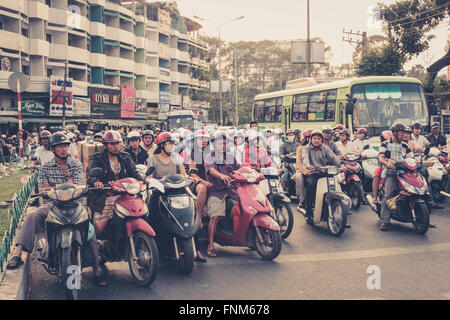 motorbike traffic in saigon, vietnam -  scooter driver waiting at traffic light Stock Photo