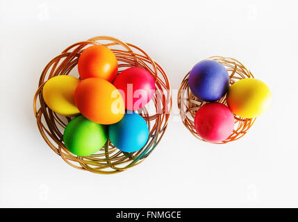 Bright multi-colored easter eggs in two baskets. Colorful easter eggs. Top view. Stock Photo