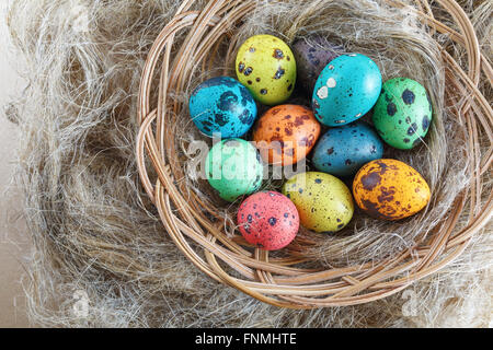 Bright multi-colored easter eggs on a soft linen background. Top view. Stock Photo