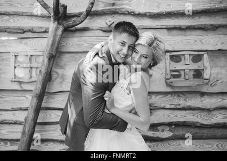 beautiful young wedding couple stands near house Stock Photo