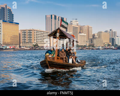 People crossing the Creek from Deira to Bur by abra, a traditional wooden water taxi in Dubai, United Arab Emirates Stock Photo