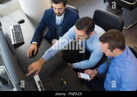Business team analyzing data on computer. Stock Photo