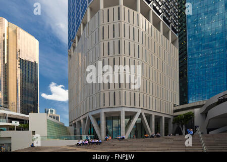 White collar office workers take lunch overshadowed by the high rise office blocks in Brisbane, Queens central business district Stock Photo