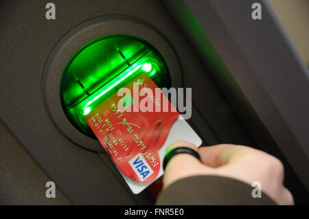 Santander Bank Cash Point with a card being inserted into machine. Stock Photo