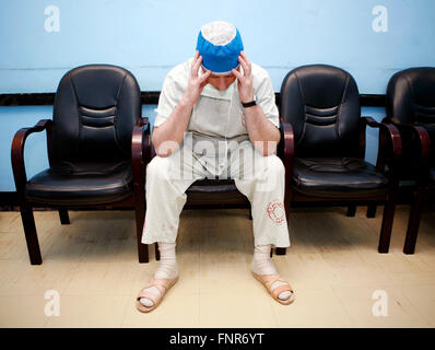 Tired surgeon resting after a long surgery Stock Photo