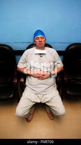 Tired surgeon resting after a long surgery Stock Photo