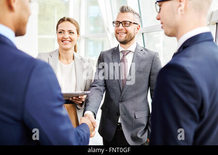 Businessmen shaking hands after meeting Stock Photo