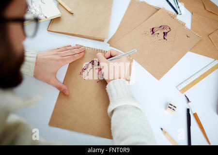 Close-up of designer drawing a fashion sketch Stock Photo