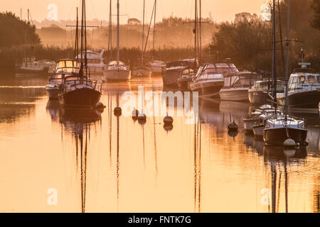 misty morning with yachts reflecting in water Stock Photo