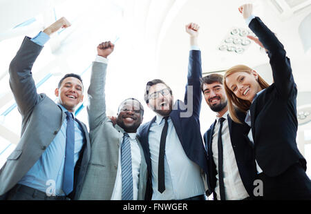 Business team raising hands and expressing triumph Stock Photo