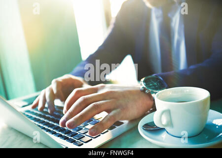 Hands of businessman typing on laptop Stock Photo