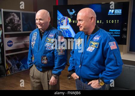 NASA astronaut Scott Kelly, left,  along with his twin brother, former Astronaut Mark Kelly, following a press conference at the Johnson Space Center March 4, 2016 in Houston, Texas. Scott Kelly become the first U.S. astronaut to spend an entire year in space following his return on March 2 from the International Space Station. Stock Photo