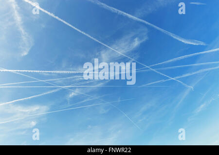 Airplane trails on blue sky Stock Photo