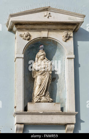Ancient stone wall with Virgin Mary bas relief in Piran, Slovenia Stock Photo