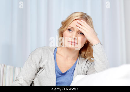 woman suffering from headache at home Stock Photo