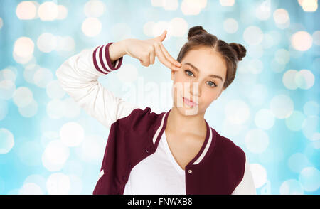 bored teenage girl making finger gun gesture Stock Photo