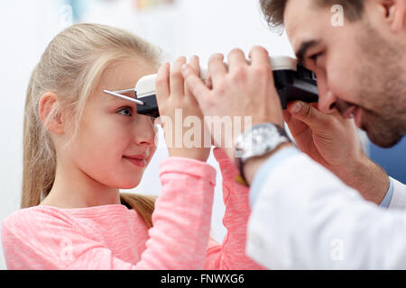 optician with pupilometer and patient Stock Photo