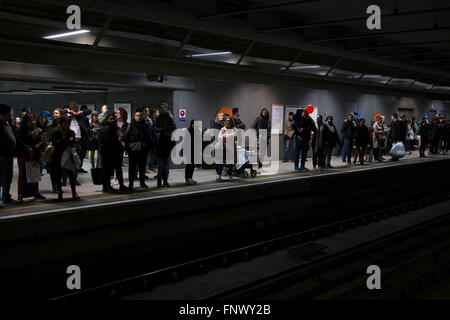 People waiting on the platform at Canada Water Overground station. Public transport system at a busy time of day in London, England, UK. Stock Photo